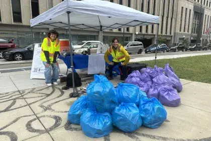 Participants posing in front of bagged litter