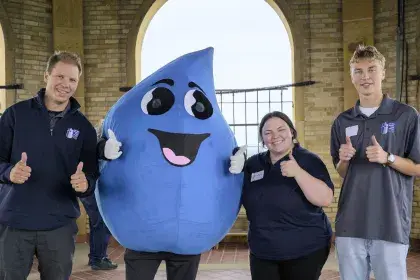 SPRWS Mascot Willy Water poses with SPRWS staff at the top of the Highland Water Tower at 2025 open house event