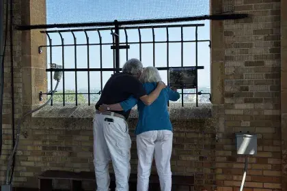 Couple embrace as they view the scenery from the top of Highland Water Tower during 2026 Open House event