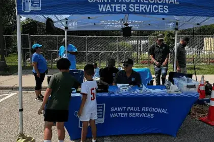 SPRWS Community Engagement Staff provides candy to kids at booth