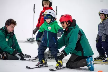 Youth taking ski lessons