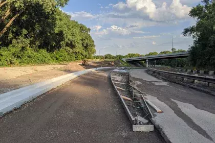 Ayd Mill Road construction photo. View of new curb at Jefferson Avenue ramp realignment. Overpass in background is Jefferson Avenue. Photo taken facing south east.